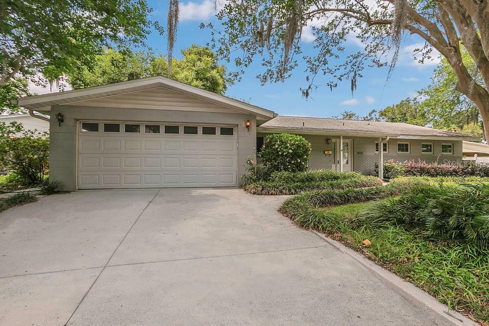 3605 Pershing Avenue Orlando, FL 32812 - Photo 3 of 35 a front view of a house with a garden