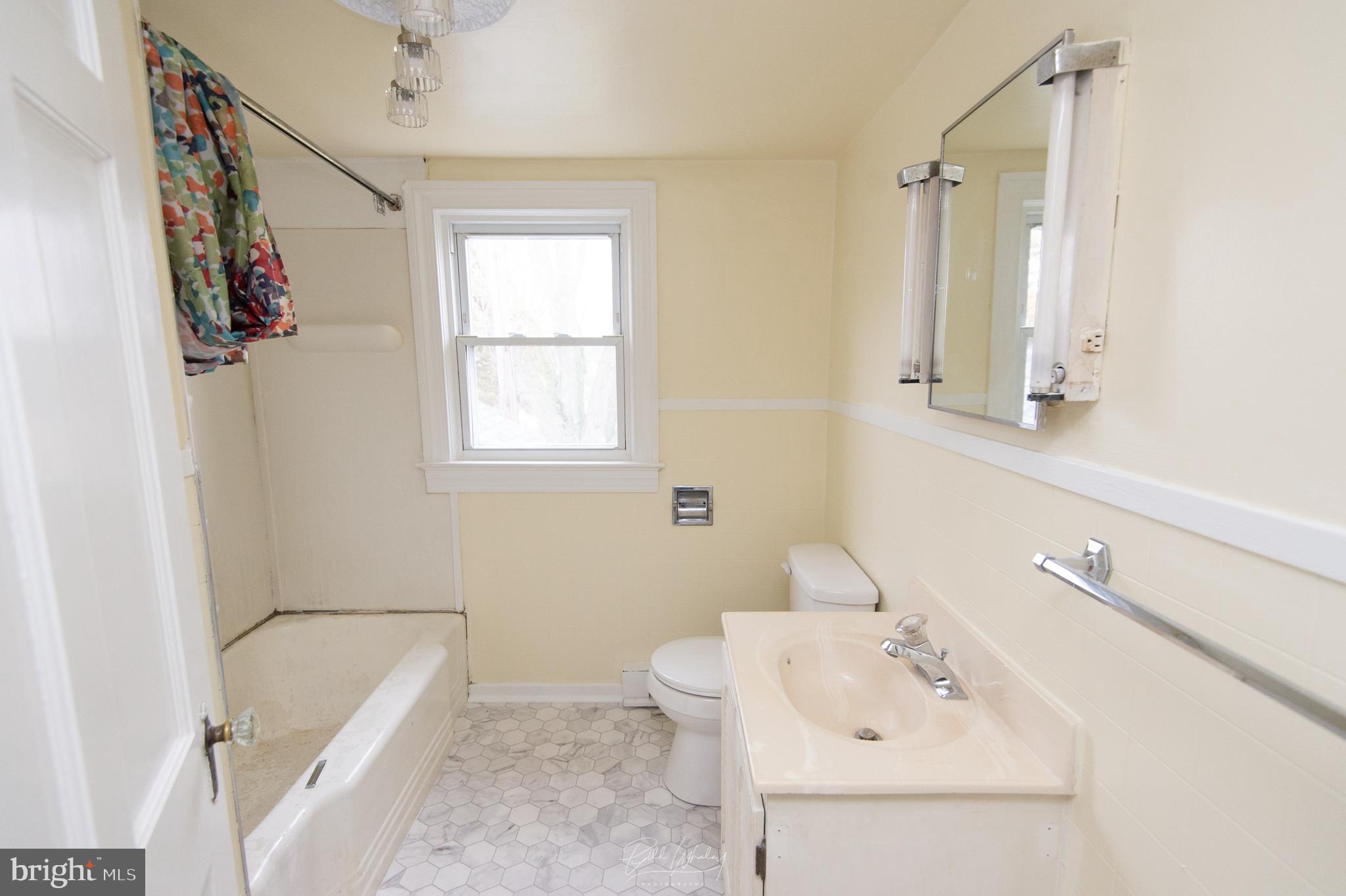 5902 Shiloh Church Hurlock Road Hurlock, MD 21643 - Photo 18 of 21 a bathroom with a sink a toilet and shower