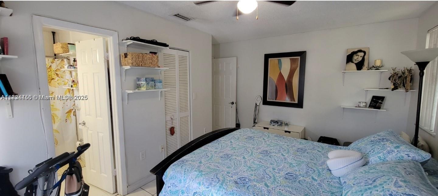 7121 Southwest 129th Avenue, Unit 5 Miami, FL 33183 - Photo 13 of 19 a bedroom with a bed and a window