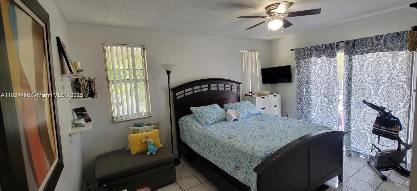 7121 Southwest 129th Avenue, Unit 5 Miami, FL 33183 - Photo 14 of 19 a bedroom with a bed and wooden floor