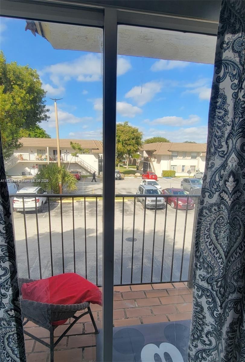 7121 Southwest 129th Avenue, Unit 5 Miami, FL 33183 - Photo 17 of 19 a view of a balcony with furniture