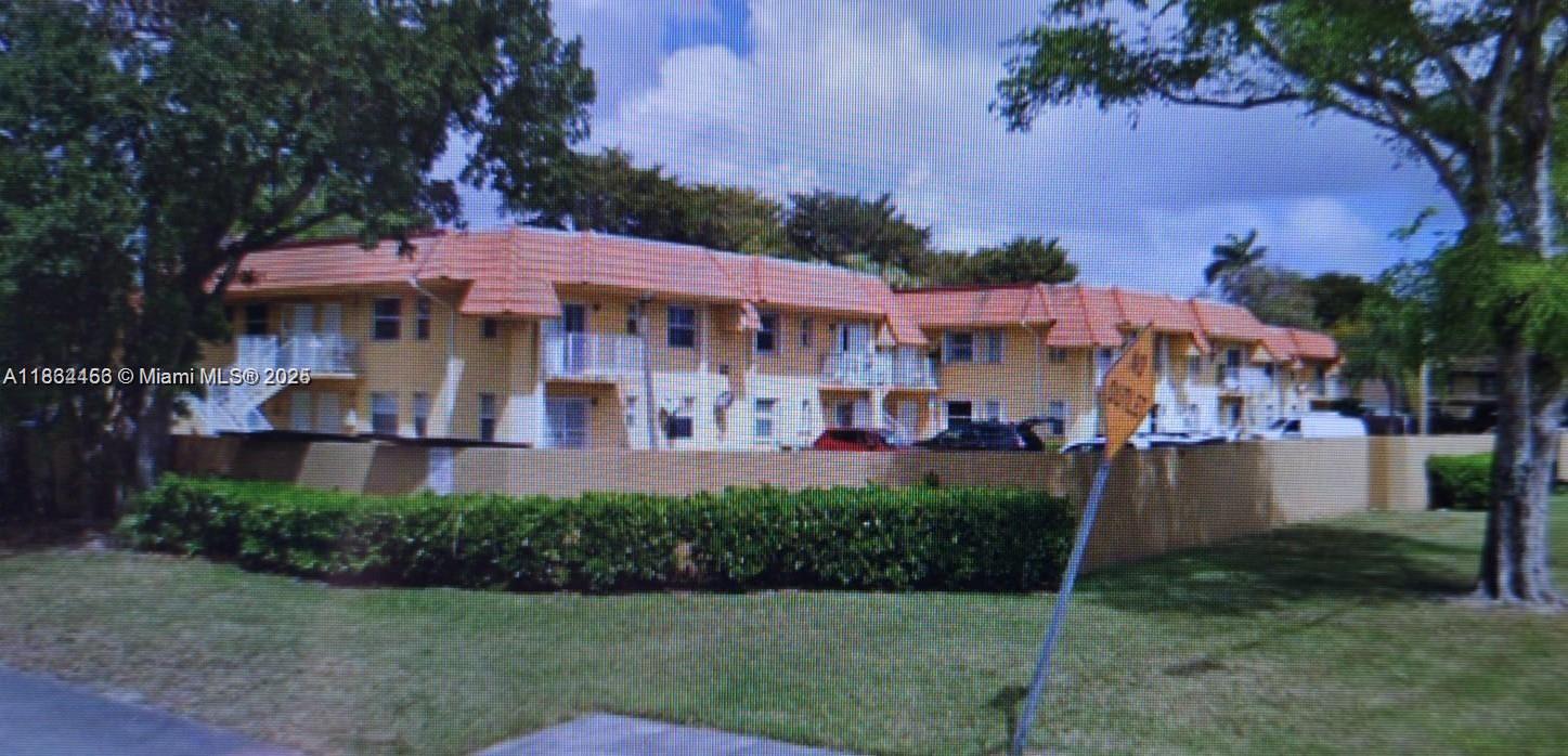 7121 Southwest 129th Avenue, Unit 5 Miami, FL 33183 - Photo 19 of 19 a view of a patio with table and chairs potted plants and large tree