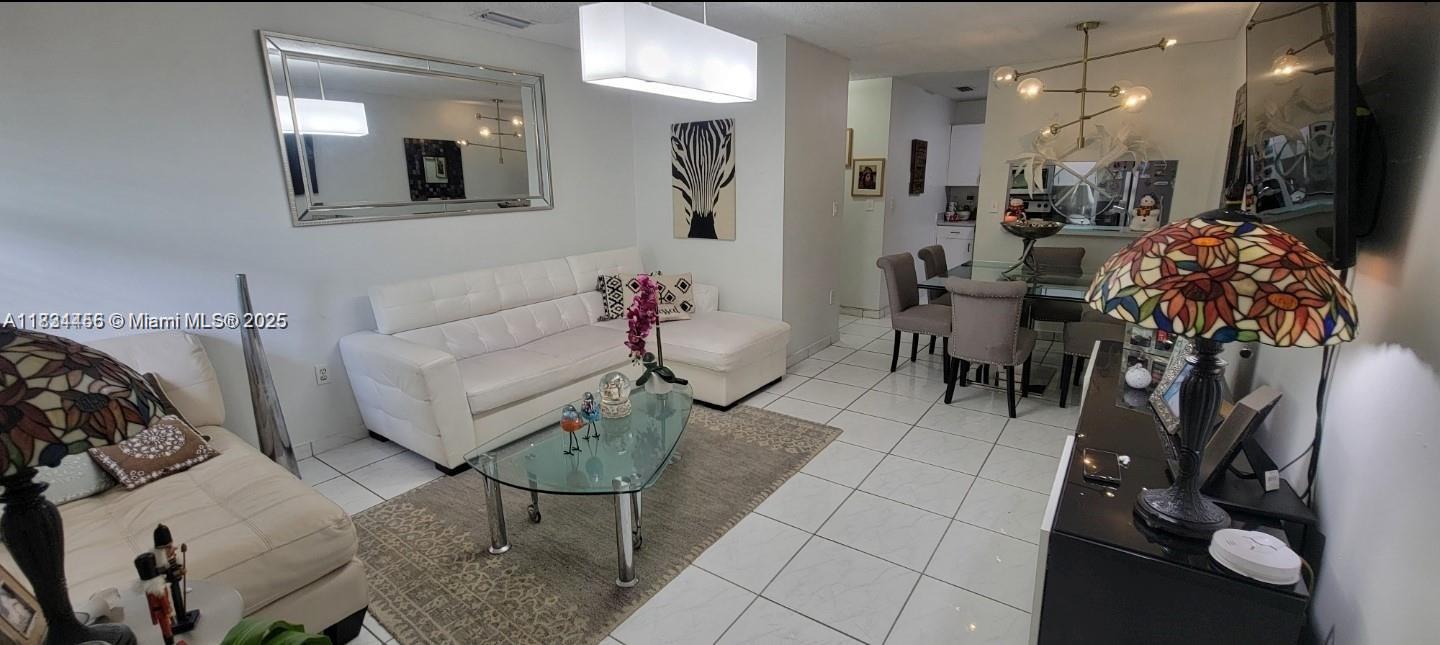 7121 Southwest 129th Avenue, Unit 5 Miami, FL 33183 - Photo 4 of 19 a living room with furniture and a mirror