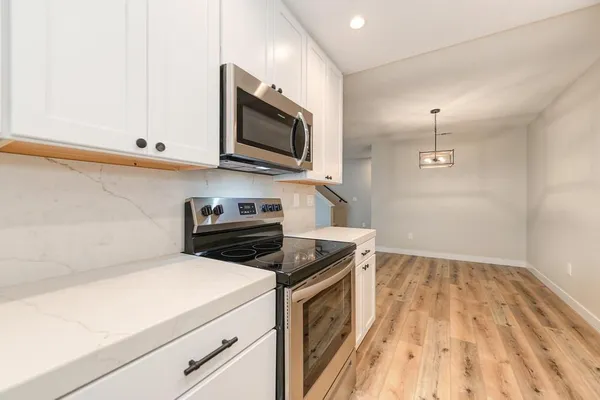 a kitchen with a stove and a microwave