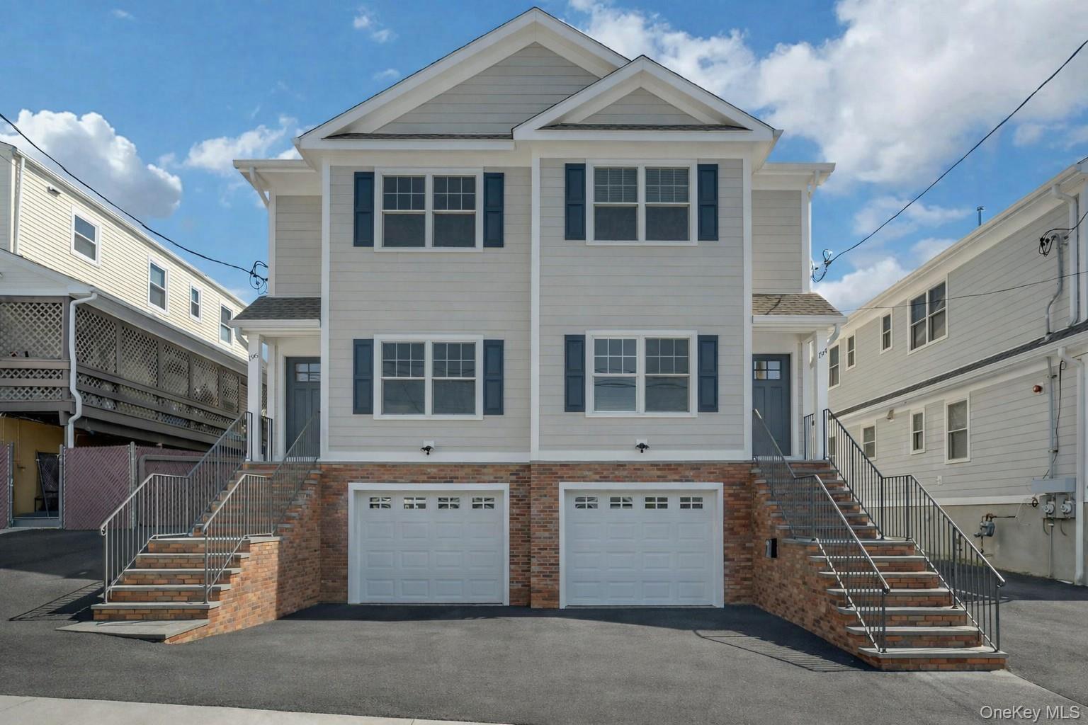 194 Gainsborg Avenue East, Unit RIGHT SIDE West Harrison, NY 10604 - Photo 1 of 1 a front view of a house with a garage