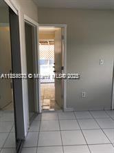 3121 Northwest 103rd Street, Unit 3 Miami, FL 33147 - Photo 5 of 6 a view of a room with rack on the wall