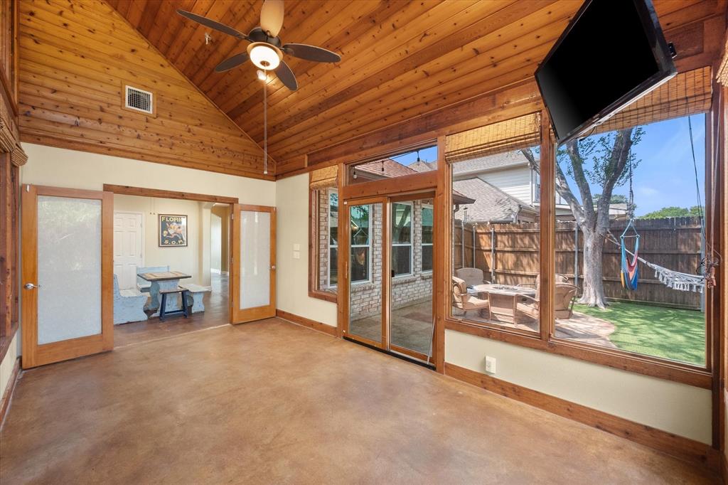 1305 Liverpool Lane Mansfield, TX 76063 - Photo 33 of 40 Spacious sunroom featuring a vaulted wood-paneled ceiling, a ceiling fan, and large windows with outdoor views