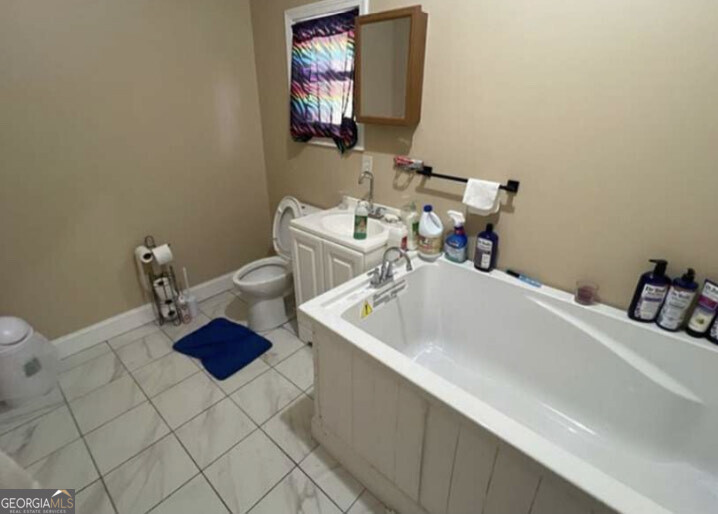 3209 Peachtree Street Lithia Springs, GA 30122 - Photo 8 of 8 a bathroom with a sink and a mirror