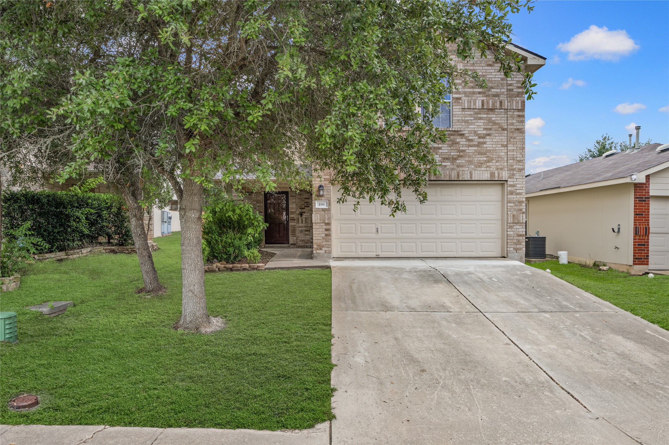 198 Black Forest Road Buda, TX 78610 - Photo 1 of 23 A well-maintained brick facade and verdant landscaping offer appealing curb appeal.