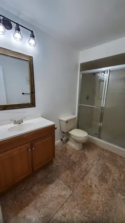 a bathroom with a sink a toilet and mirror
