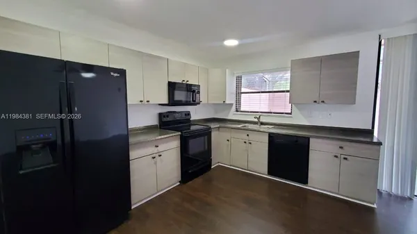 a kitchen with a sink stove and refrigerator