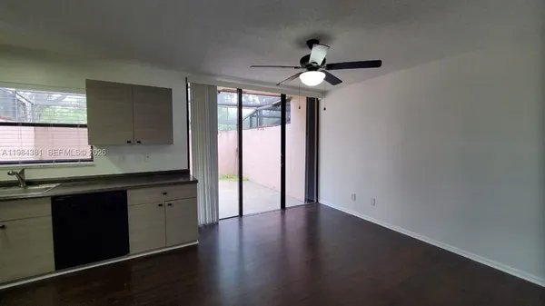 a view of a kitchen with a sink and a window