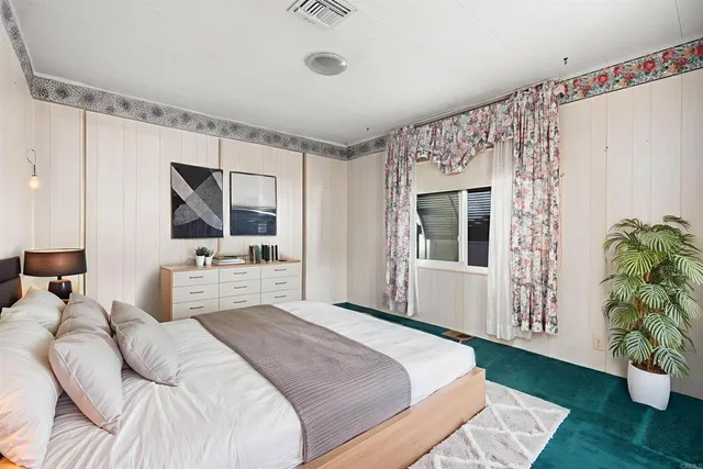 a bedroom with a large bed and a window