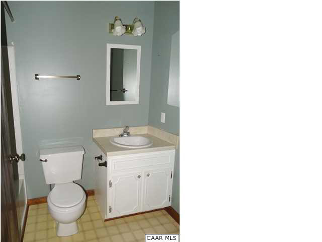 14121 Reva Road Boston, VA 22713 - Photo 15 of 16 a bathroom with a toilet a sink and mirror