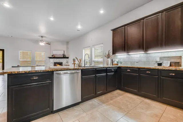 a kitchen with a sink cabinets and stainless steel appliances