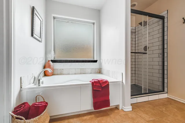 a bathroom with a tub sink and shower