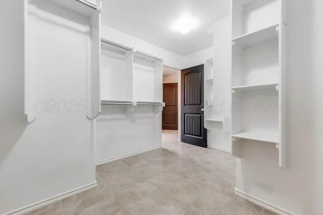 a view of an empty room with closet area