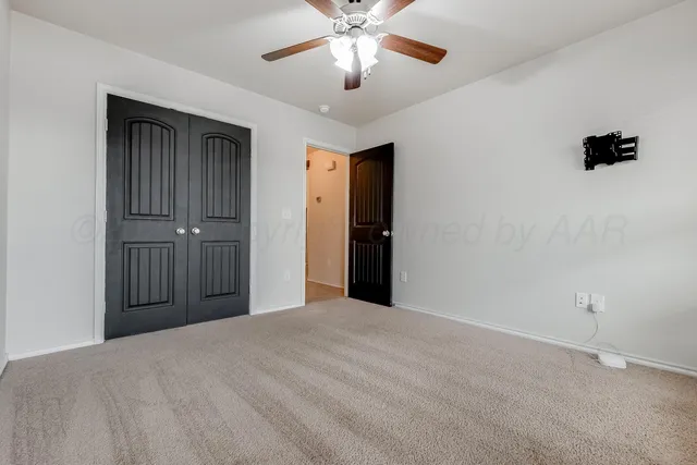 a view of a livingroom with a chandelier fan