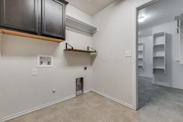 a view of storage and utility room with closet