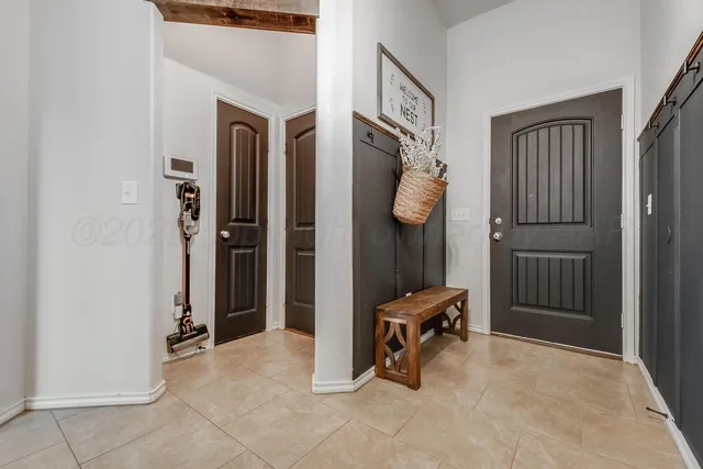 a view of a hallway with elevator and glass door