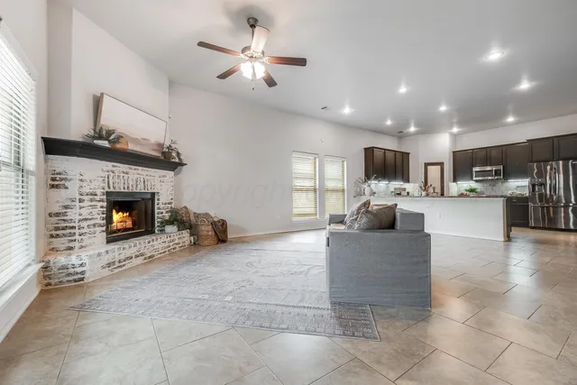 a living room with furniture and a fireplace