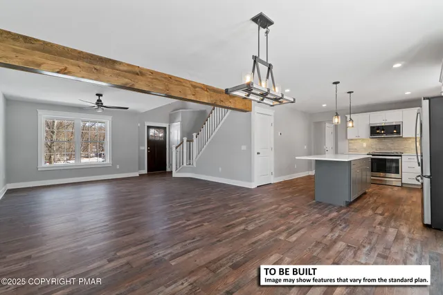 a view of a room with wooden floor and kitchen view