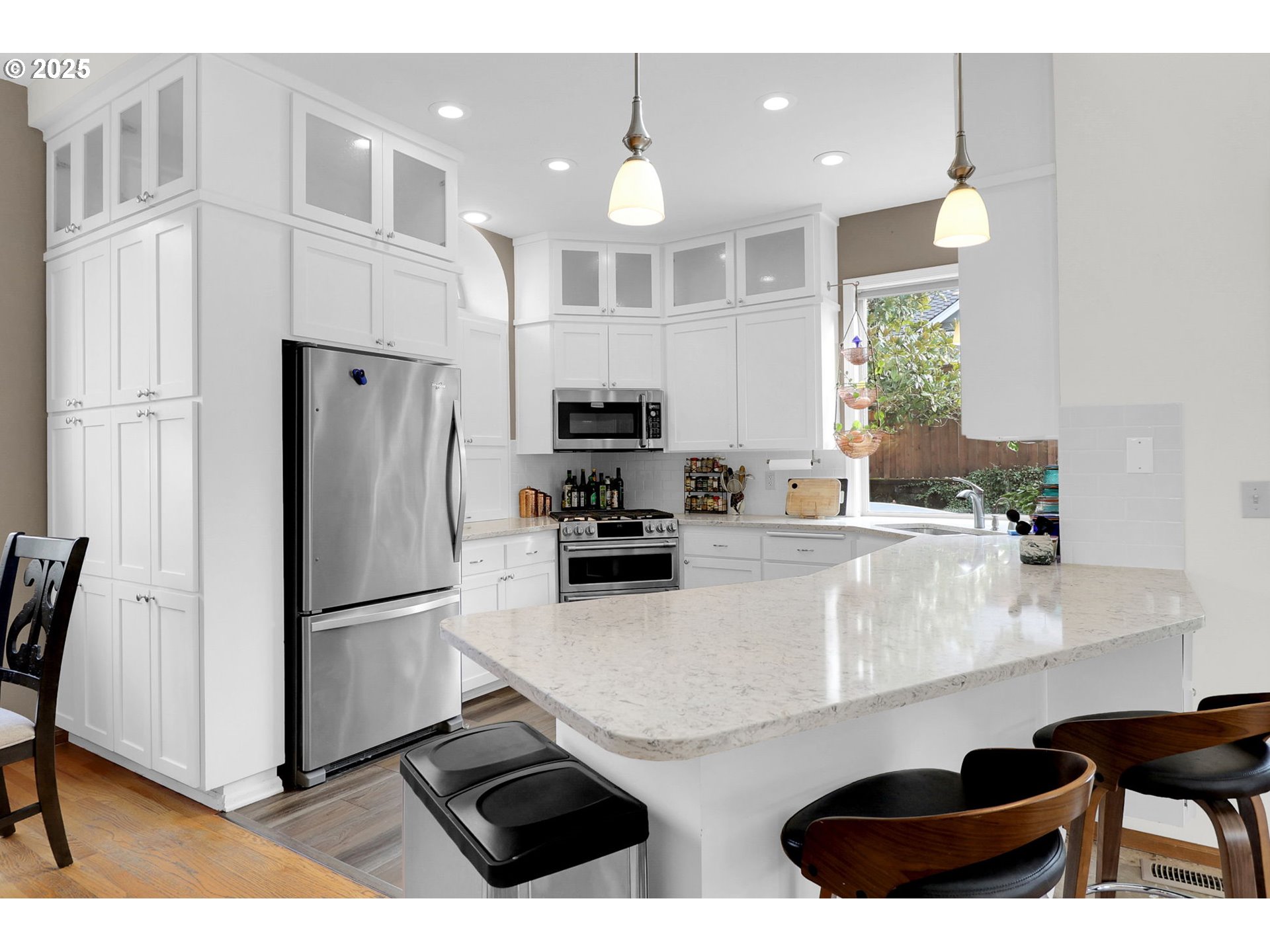 2708 Moon Mountain Drive Eugene, OR 97403 - Photo 5 of 43 a kitchen with stainless steel appliances granite countertop a refrigerator a sink a stove and chairs with wooden floor