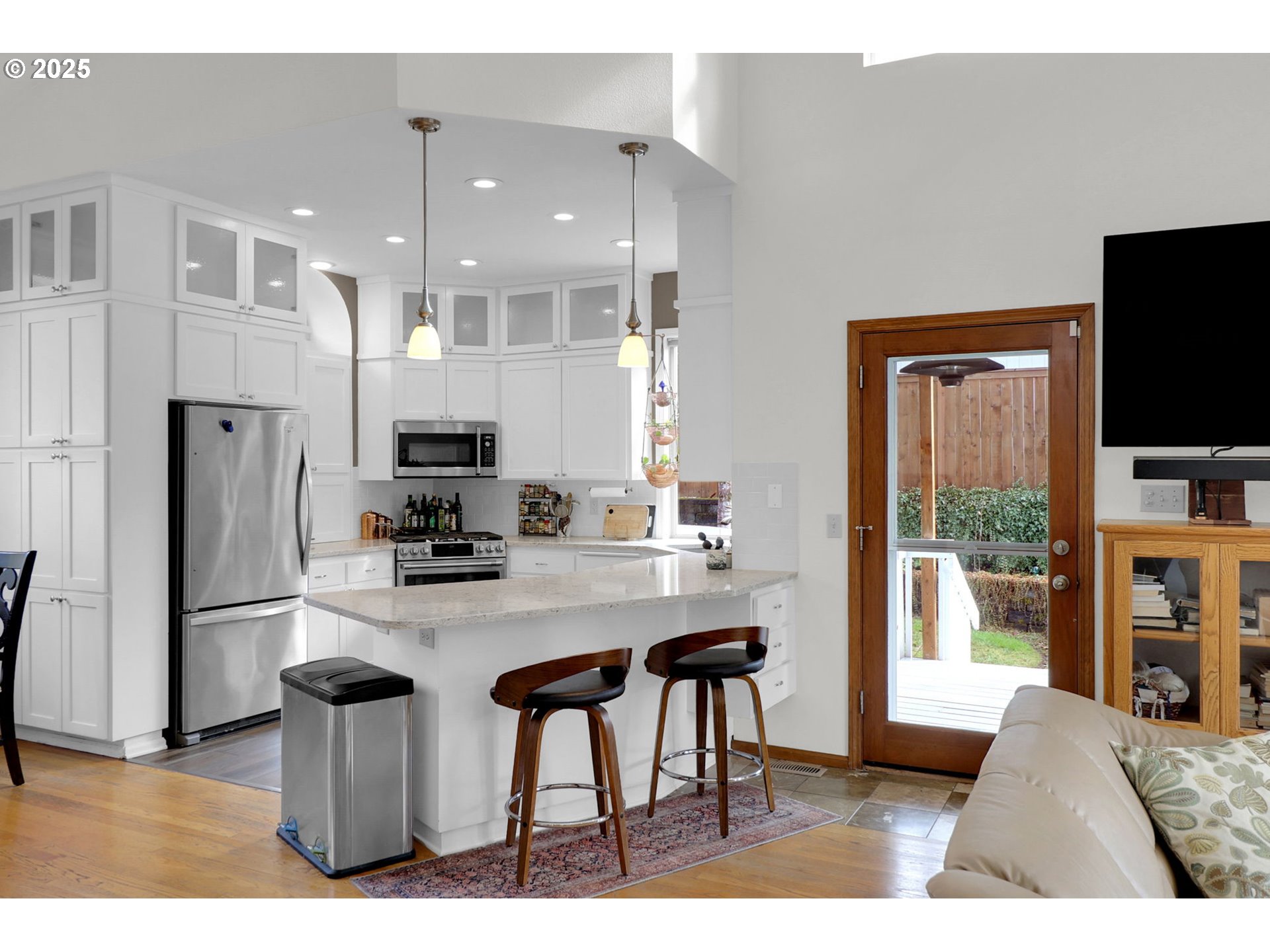 2708 Moon Mountain Drive Eugene, OR 97403 - Photo 10 of 43 a kitchen with stainless steel appliances a dining table chairs refrigerator and microwave