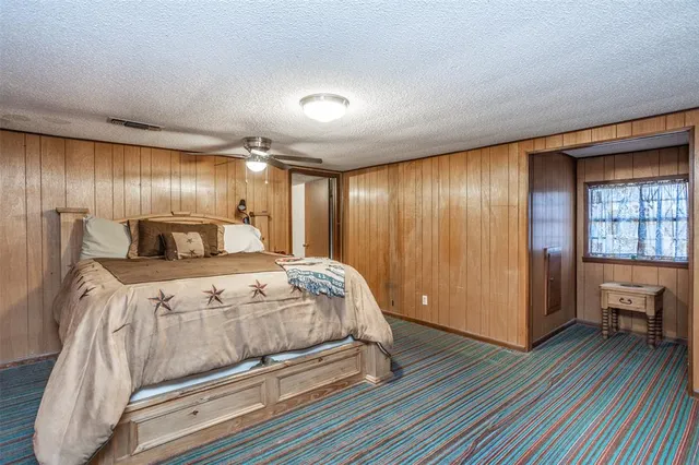 a bedroom with a bed and a large window