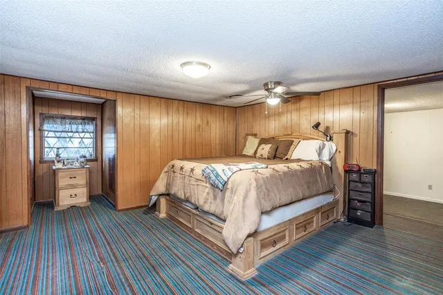 a bedroom with a bed and glass door