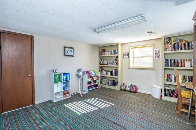 a bedroom with furniture and a book shelf