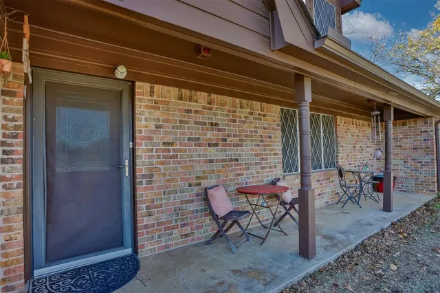 a brick building with a bench in front of it