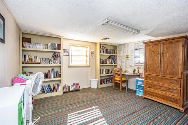 a view of a workspace with furniture and wooden floor