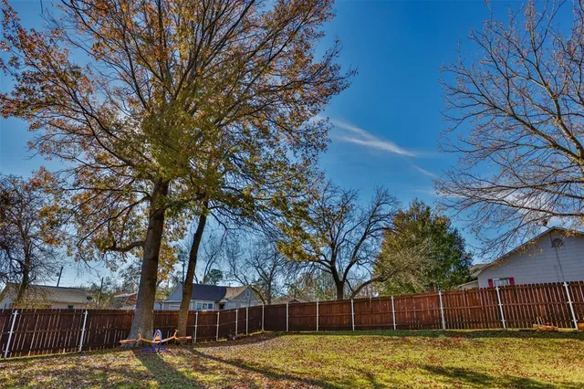 a view of a yard with large trees