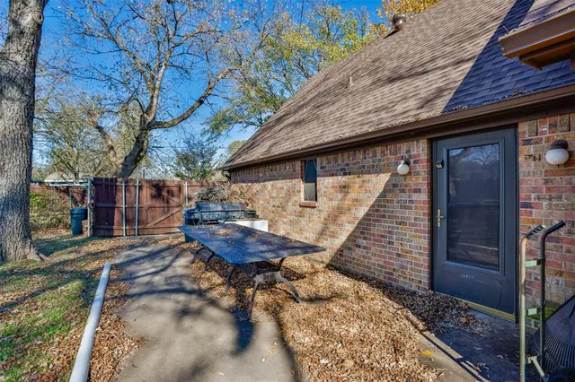 a backyard of a house with table and chairs