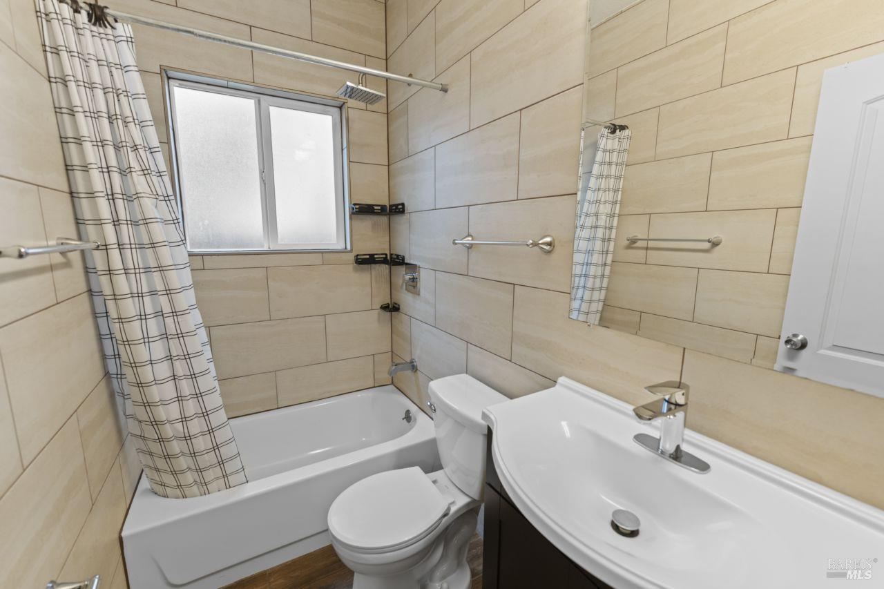 940 York Street Vallejo, CA 94590 - Photo 15 of 30 a bathroom with a bathtub shower sink vanity and toilet