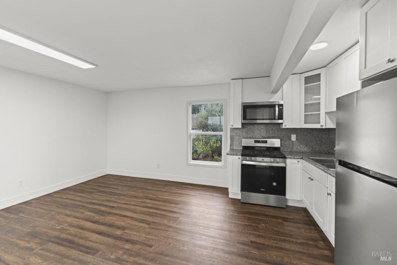 940 York Street Vallejo, CA 94590 - Photo 21 of 30 a kitchen with granite countertop a refrigerator stove top oven and sink