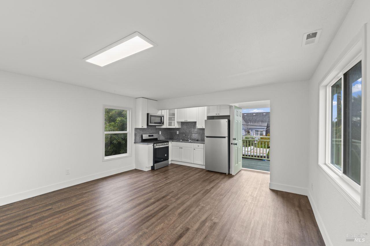 940 York Street Vallejo, CA 94590 - Photo 22 of 30 a kitchen with stainless steel appliances wooden floors and white walls