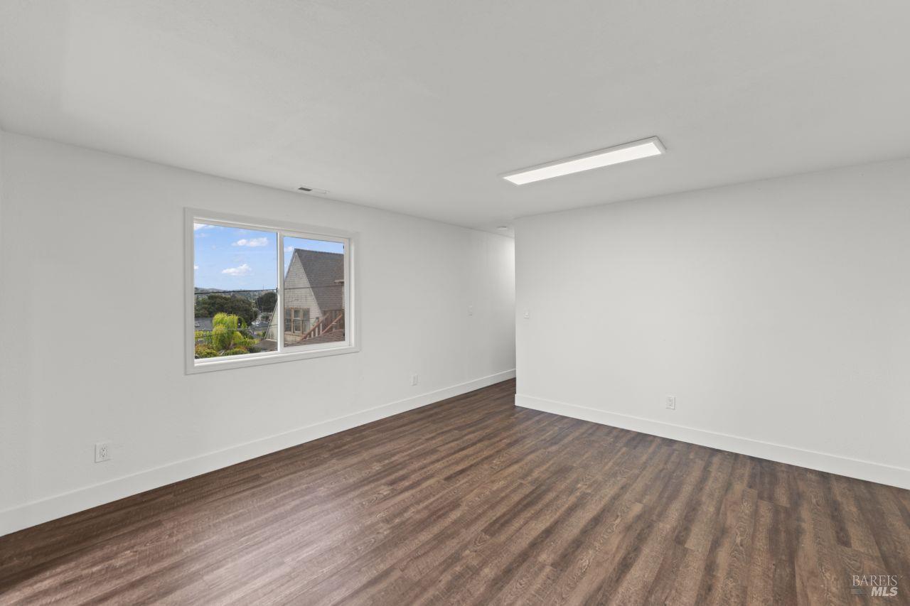 940 York Street Vallejo, CA 94590 - Photo 23 of 30 a view of an empty room with wooden floor and a window