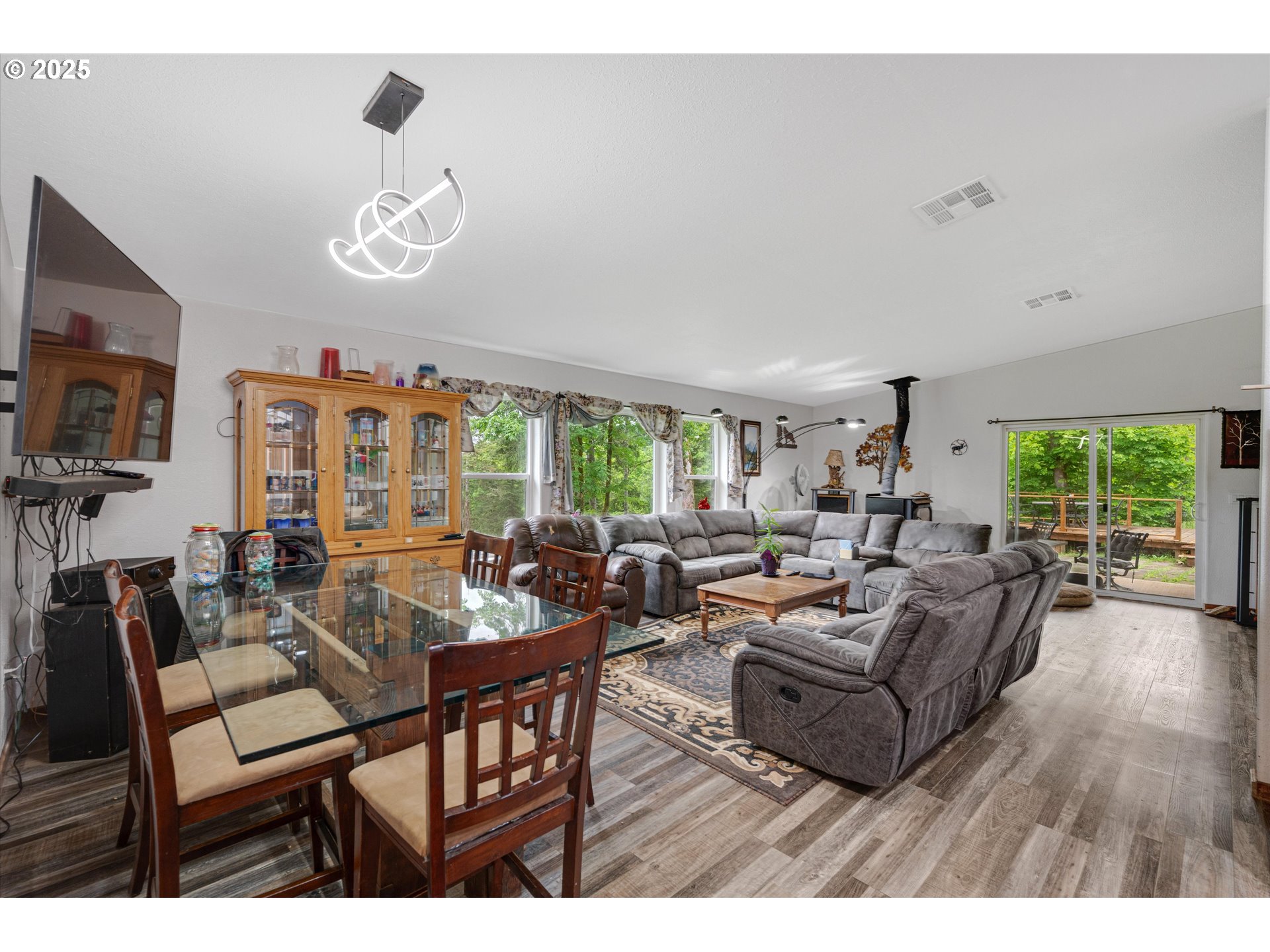 17205 Oakdale Road Dallas, OR 97338 - Photo 14 of 36 a living room with furniture chandelier and a large window