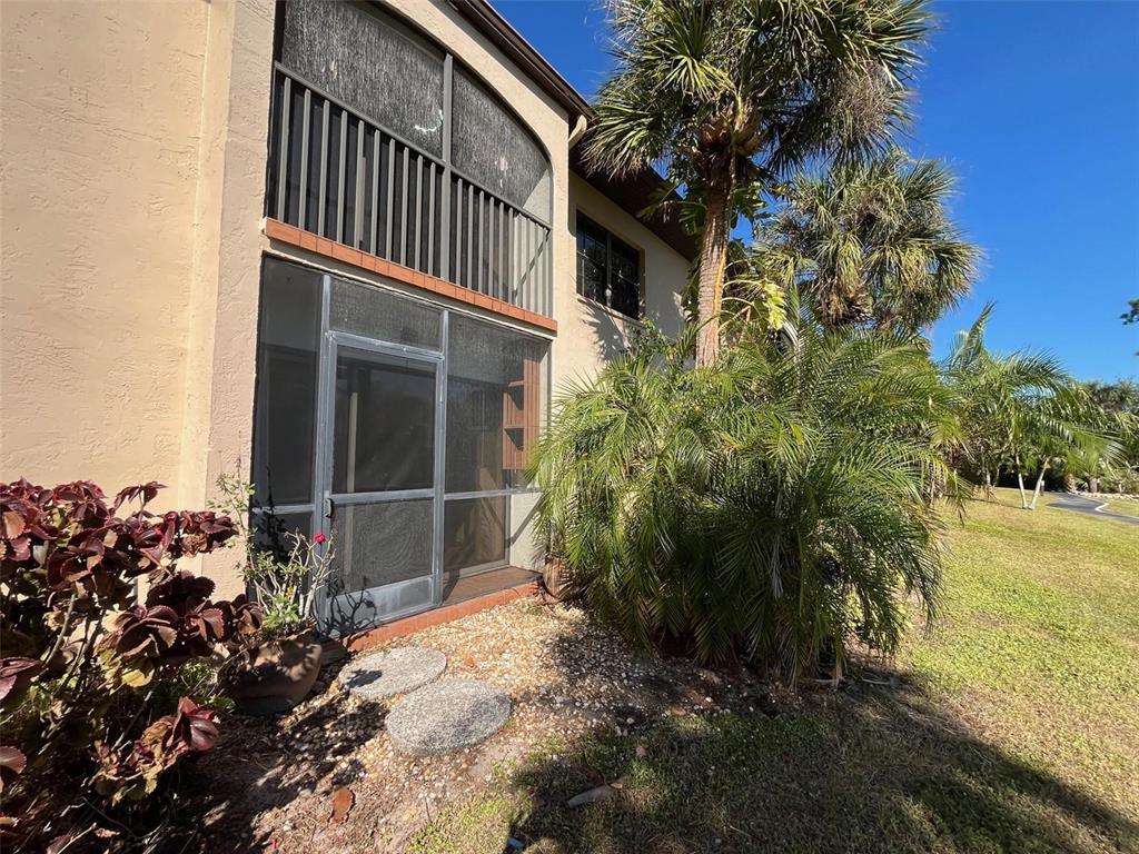 23465 Harbor View Road, Unit 1006 Punta Gorda, FL 33980 - Photo 27 of 41 a backyard of a house with lots of green space