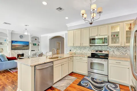 a kitchen with a sink stove and microwave