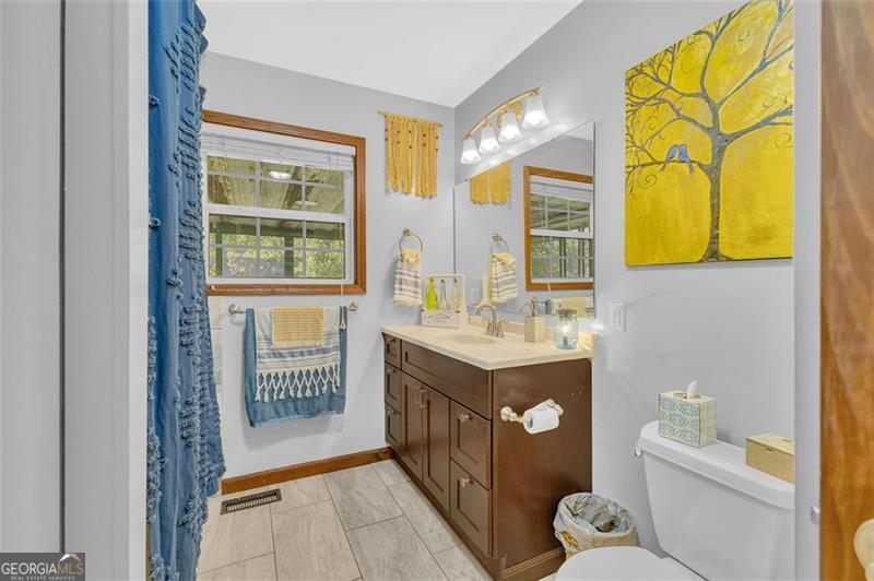 340 Tom Bell Road Milner, GA 30257 - Photo 19 of 34 a bathroom with sink and mirror with bathtub