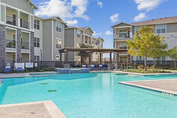 a front view of building and yard with swimming pool