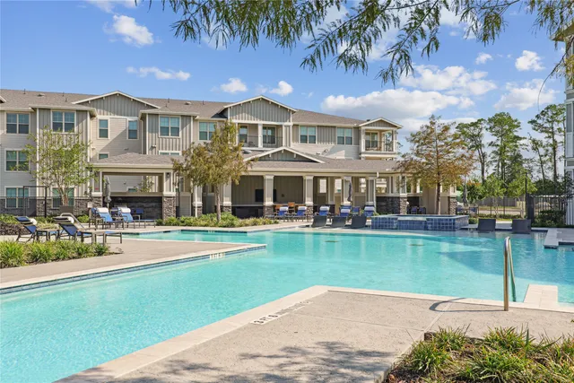 a front view of a house with swimming pool having outdoor seating
