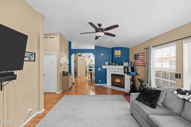 a living room with furniture a fireplace and a flat screen tv