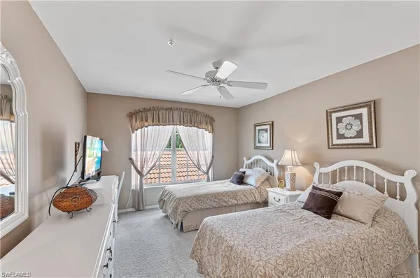 a bedroom with two beds and a chandelier