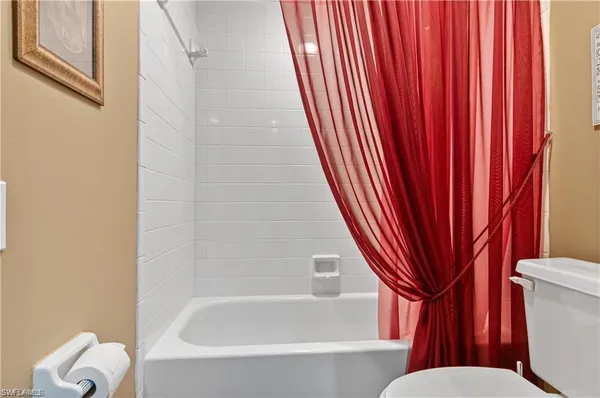 a bathroom with a toilet and a bathtub