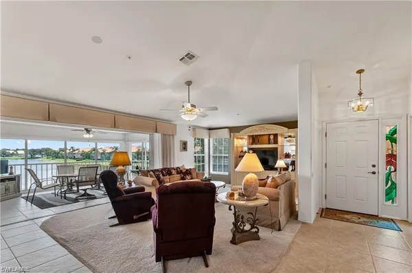 a living room with furniture a window and gym equipment