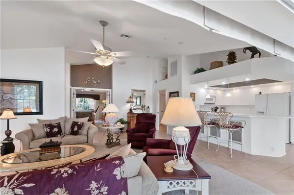 a living room with furniture chandelier and a chandelier